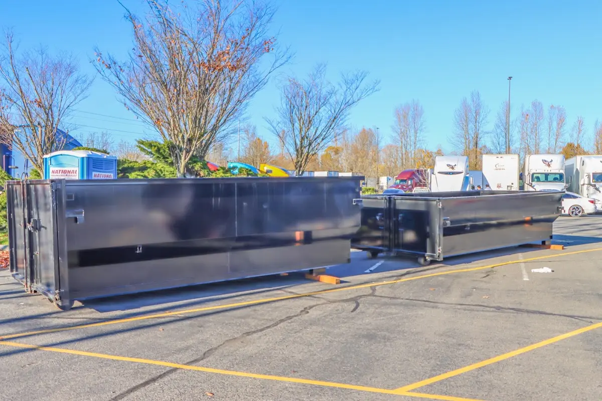 Professional dumpster rental service with roll-off container on residential driveway in Downingtown